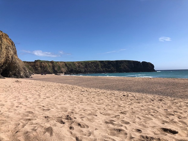 Long sandy beach with calm ocean